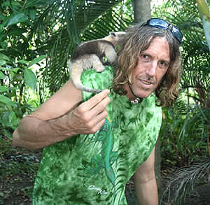 American artist Matthew Child with a baby anteater, being cared for at Rainsong Wildlife Sanctuary